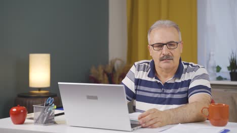 Home-office-worker-old-man-getting-bad-news-from-camera.